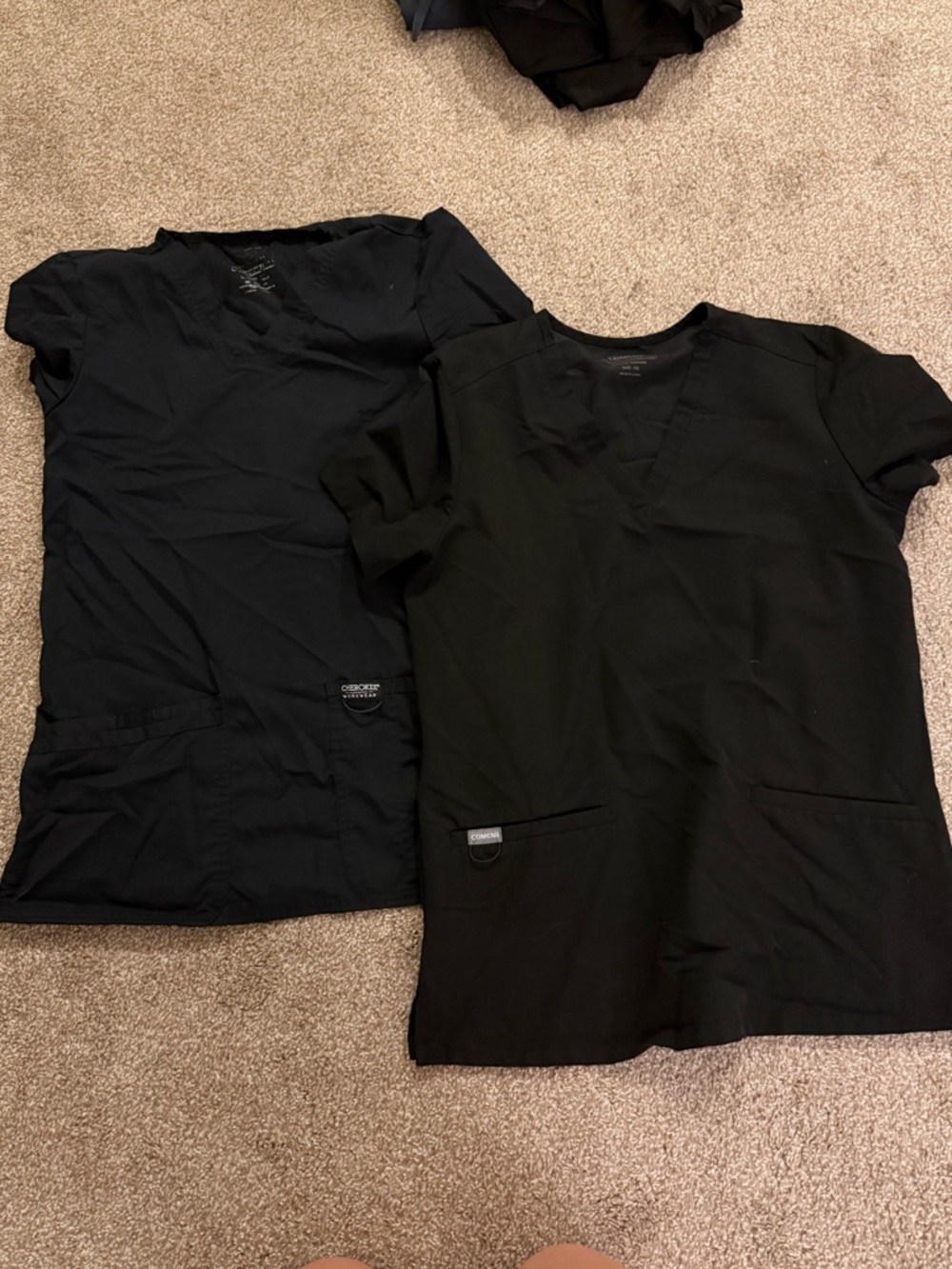 Two black scrub tops